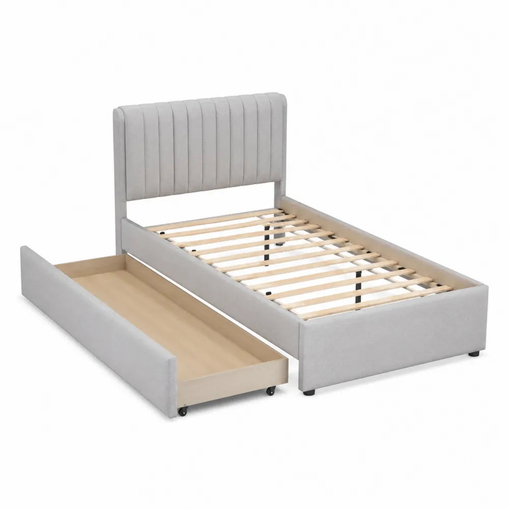 Cama individual con cabecero tapizado gris y cajón de almacenaje